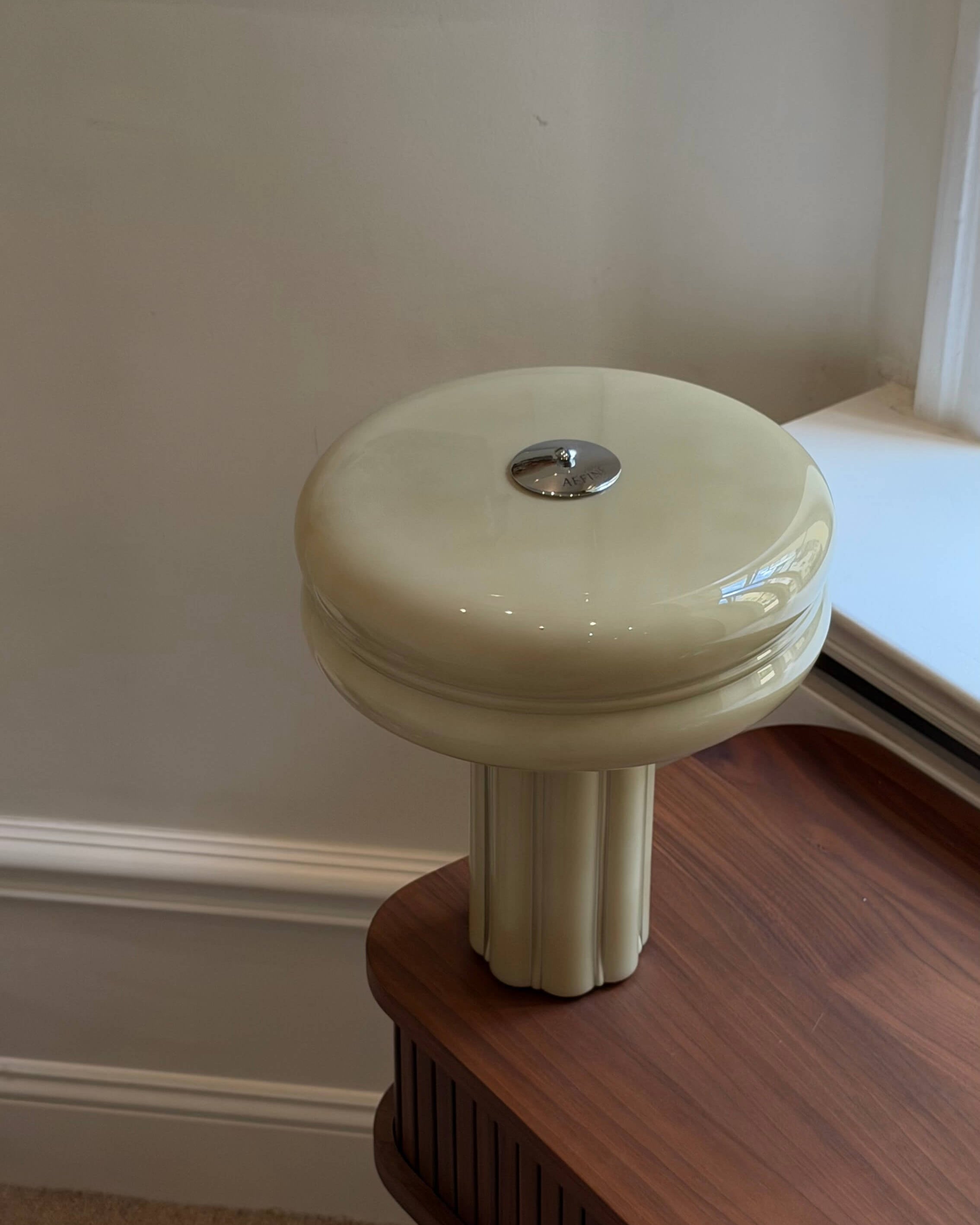 Sage Green Table Lamp standing on a walnut desk