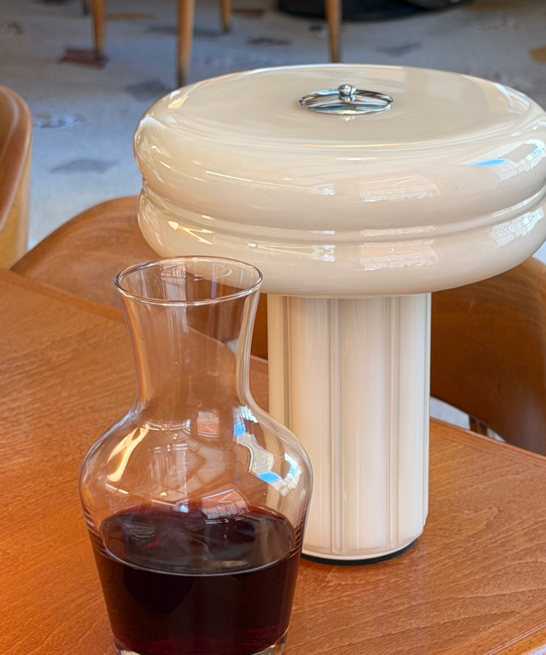 Hand-blown glass Portable Lamp in Crème Beige with polished aluminium details.