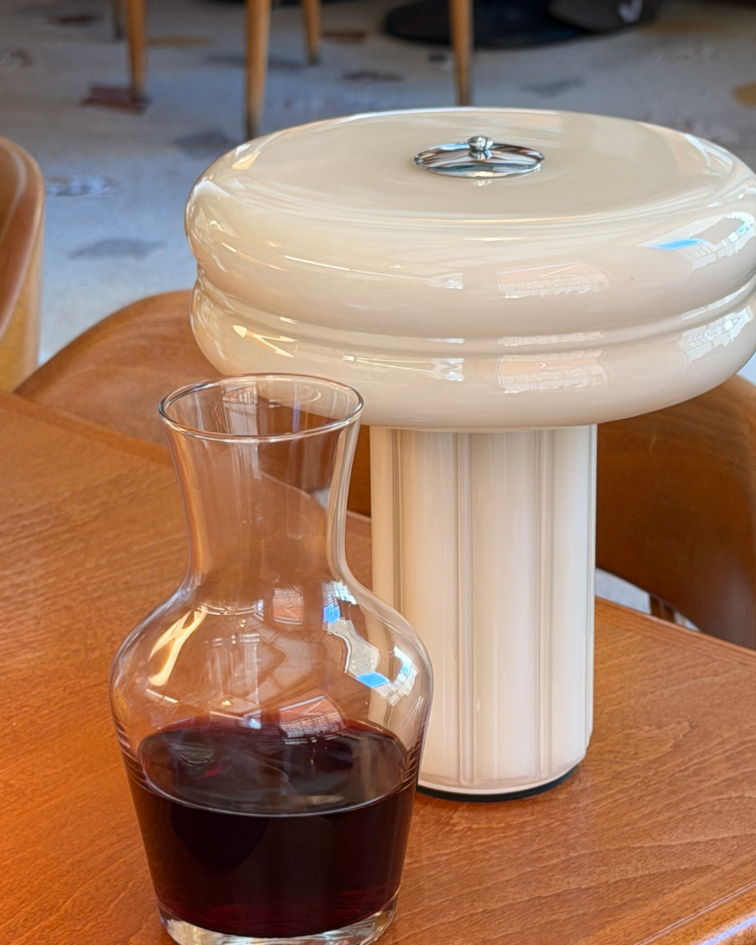 Hand-blown glass Portable Lamp in Crème Beige with polished aluminium details.