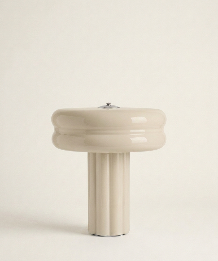 The Affiné Portable Lamp in Crème Beige – hand-blown glass with polished aluminium top.
