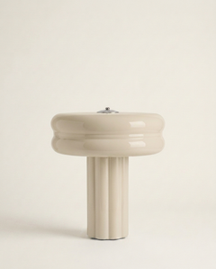 The Affiné Portable Lamp in Crème Beige – hand-blown glass with polished aluminium top.