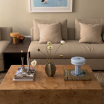 Affiné Portable Lamp in Powder Blue styled on a table.