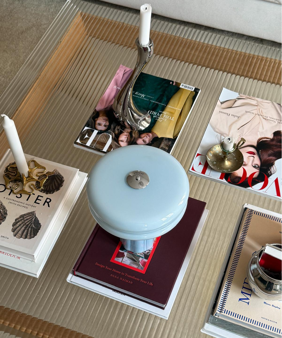 The Affiné Portable Lamp in Powder Blue casting a soft glow.