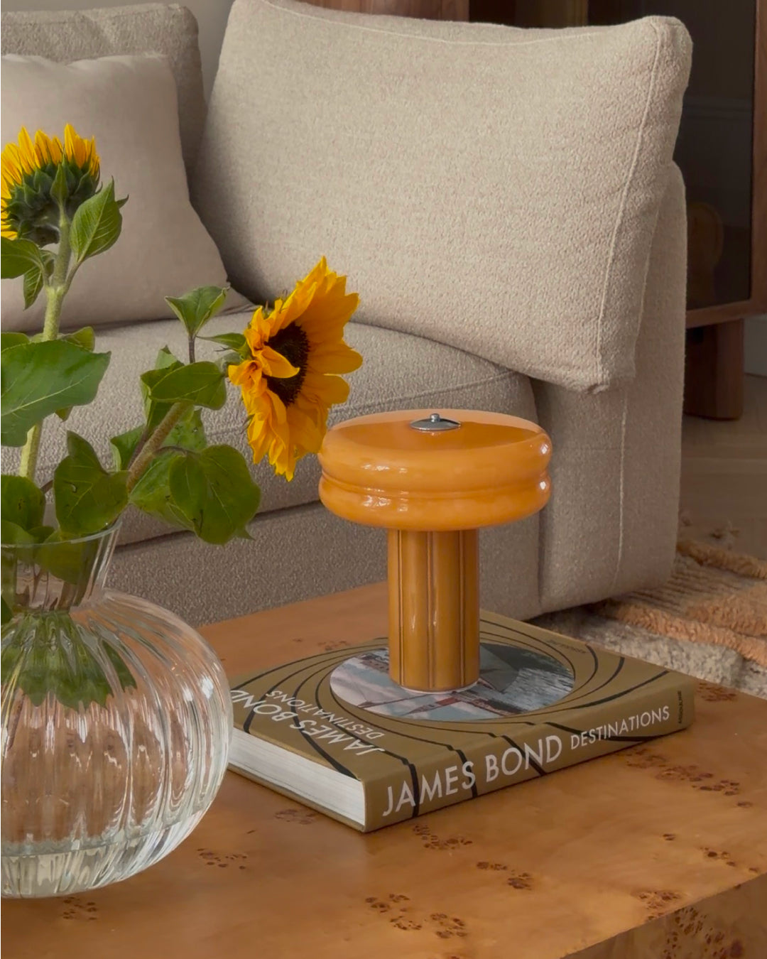 The Affiné Portable Lamp in Soft Amber casting a warm glow.