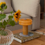 The Affiné Portable Lamp in Soft Amber casting a warm glow.