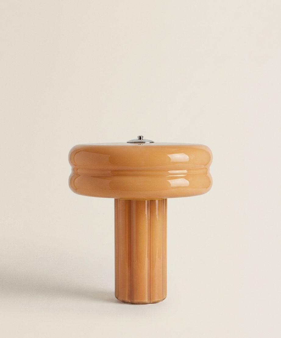 The Affiné Portable Lamp in Soft Amber – hand-blown glass with polished aluminium top.