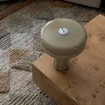 Affiné Table Lamp in Sage Green styled on a table.